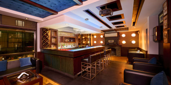 Renest Hotel Manali - Interior view of the bar featuring numerous seating options