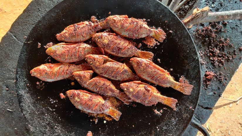 fish being fried in a pan