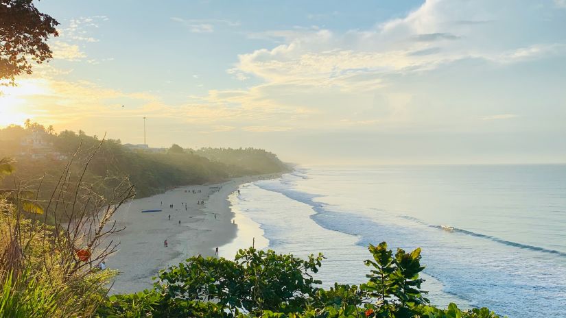 view of a beach with waves crashing the shore