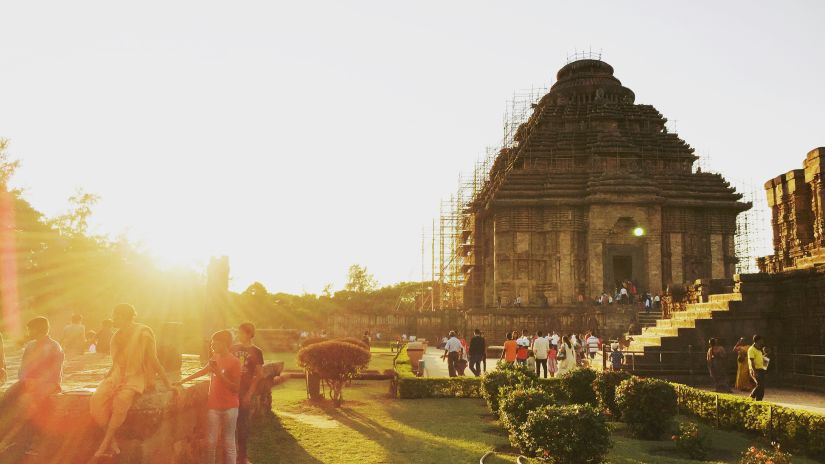 An image of a temple with a lawn spread in front of it during daytime