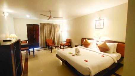 Beach Grove room with a double bed, wardrobe and seating arrangement