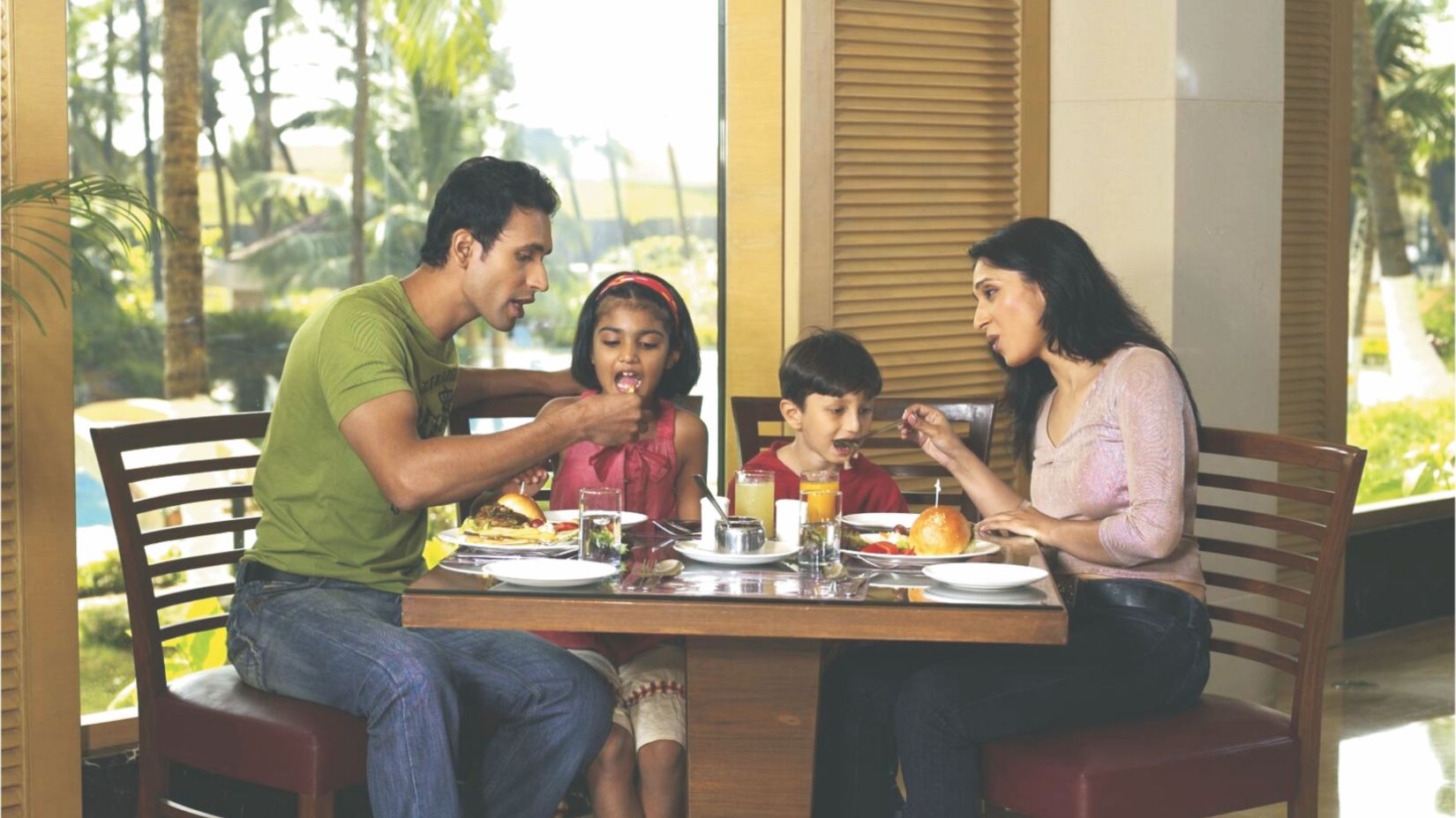 a family enjoying a meal at Lagoon The Pool View Cafe