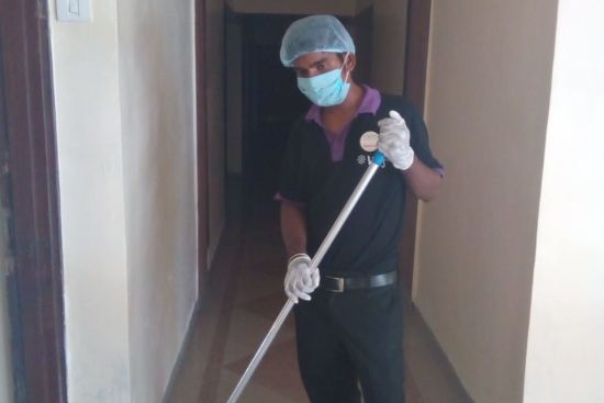 alt-text a staff cleaning the corridor at one of the hotels - vits hotels