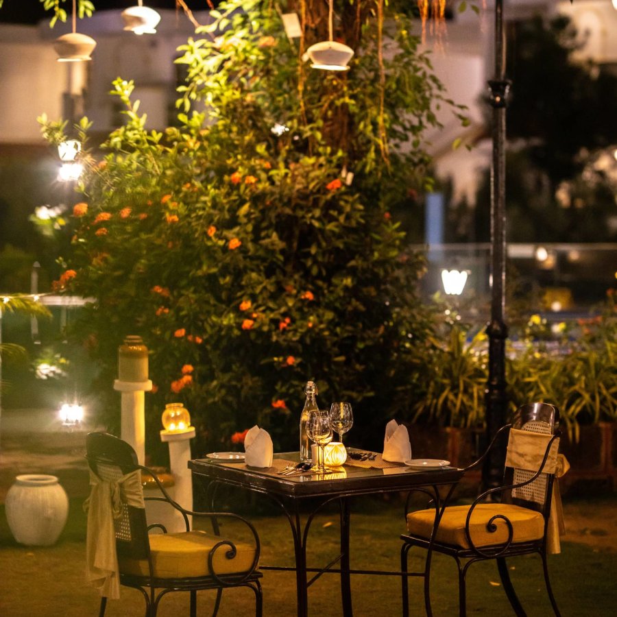 outdoor area decorated with fairly lights for a romantic dinner setup