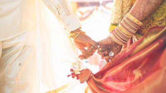 Bride and groom holding hands