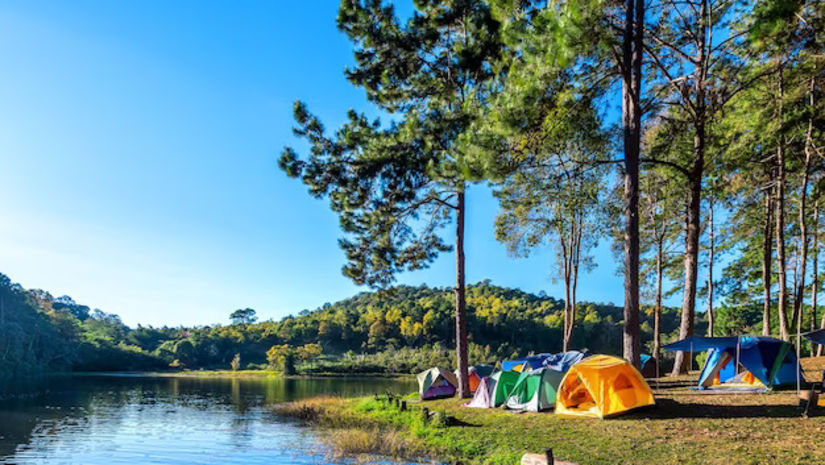 A group of tents near a lake