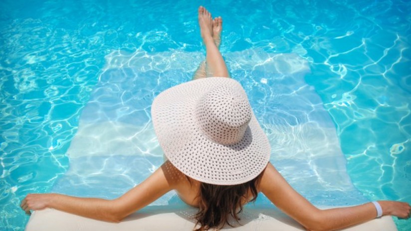 Woman lounging in the swimming pool at hablis