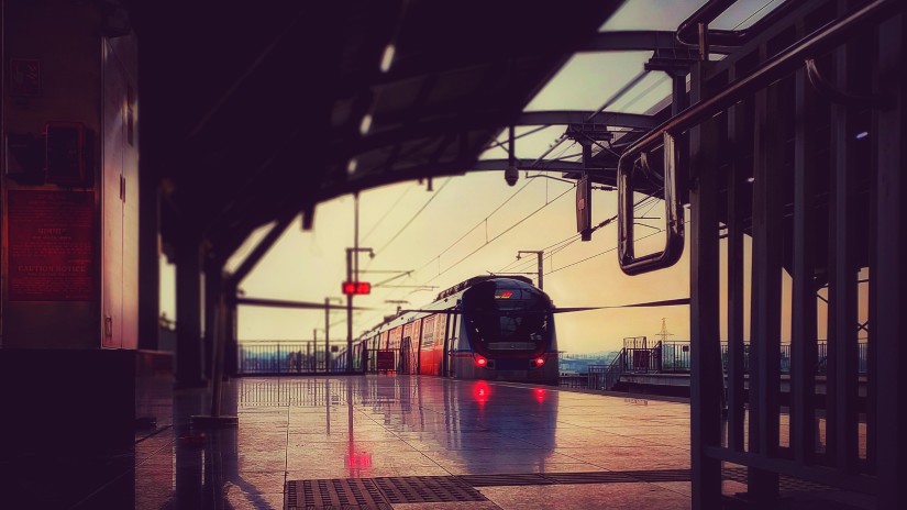 Metro travelling into a metro station in the evening