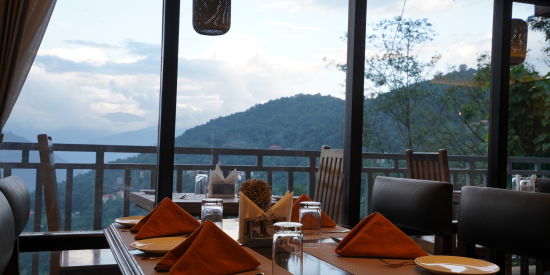 alt-text Floor to ceiling windows in restaurant with seating arrangement