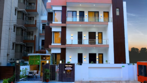 Modern multi-story hotel building facade during the evening with lights on - Lime Tree Golf View, Golf Course Road