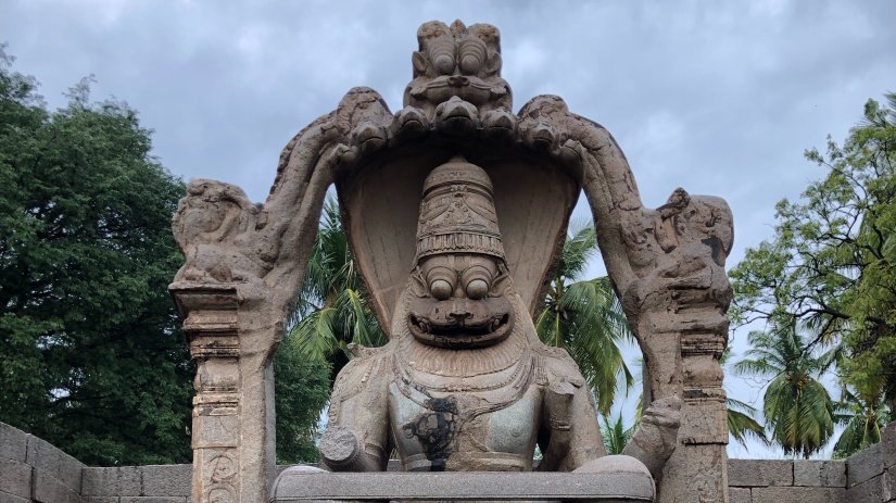 A statue of Narasimha in an old stone ruin