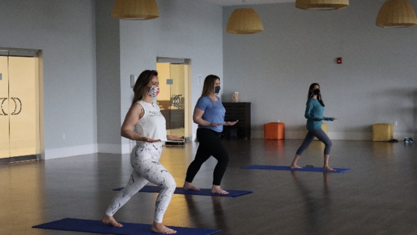 three women exercising on yoga mats