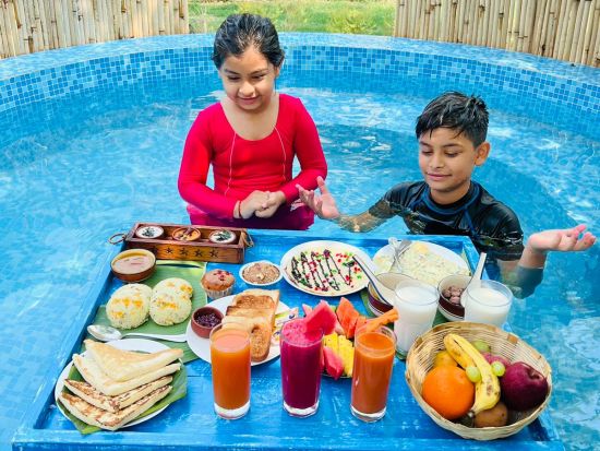 people having breakfast in pool at Themis Mudhouse - A Nature's Retreat Resort & Wellness