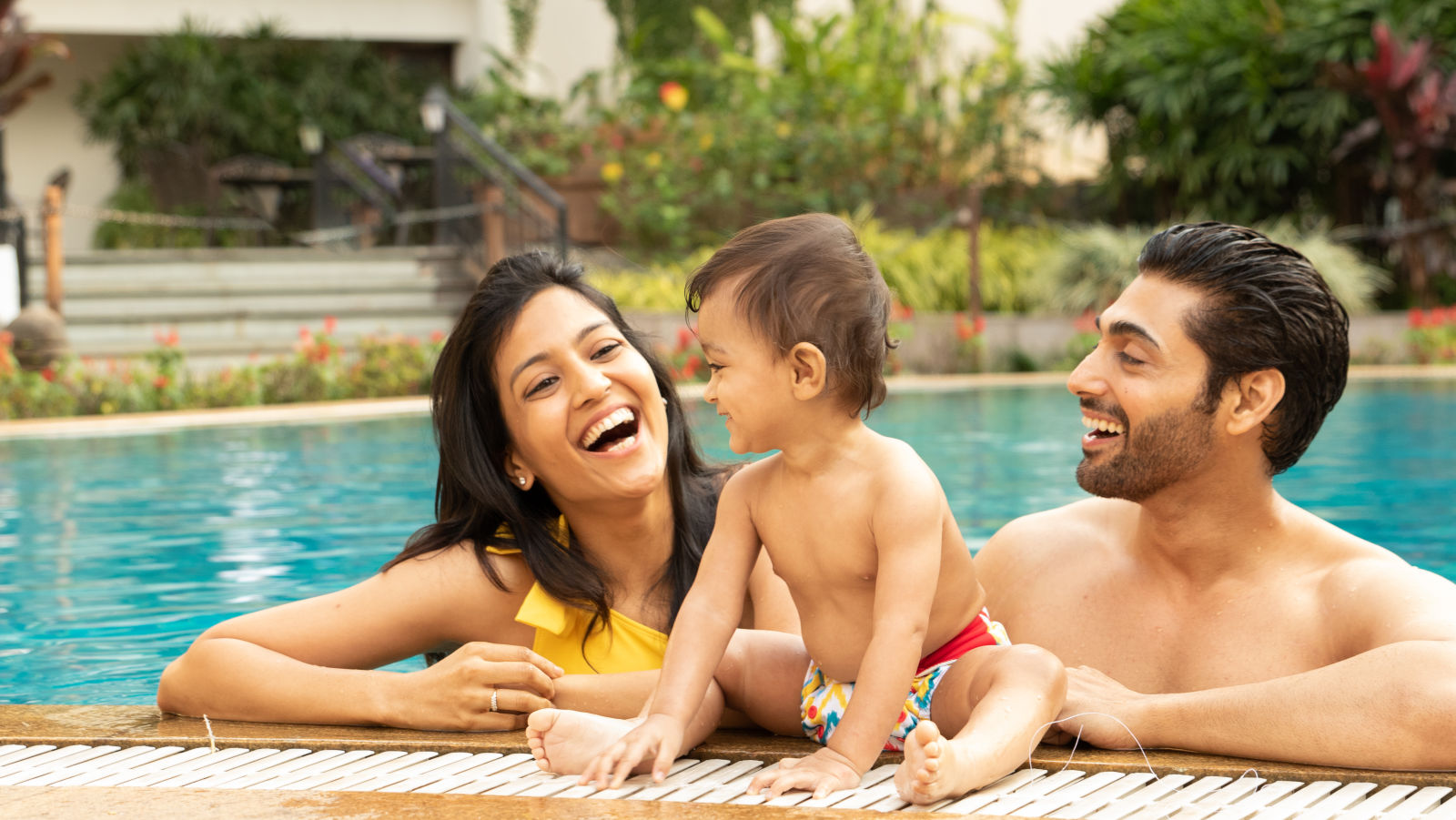 Parent and kid enjoying the swimming pool