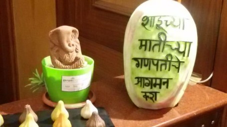 Beautiful carving of Lord Ganpatee with sweets in front