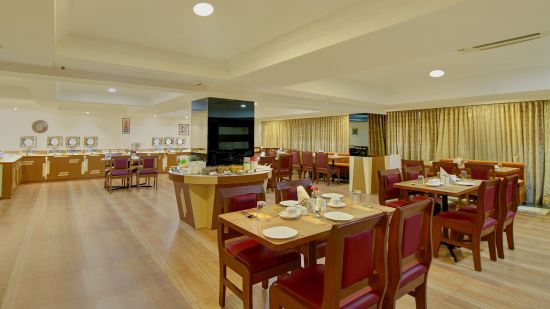 closer view of wooden furniture and buffet area at the coffee shop restaurant - the monarch hotel