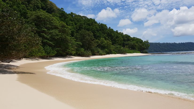 A view of a beach from seashore alongside a mountain | Barefoot at Havelock