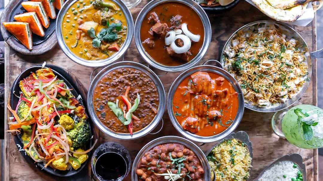 An overhead shot of various food items served in dishes and placed on a wooden table Sun Park Hotel & Banquet, Chandigarh - Zirakpur