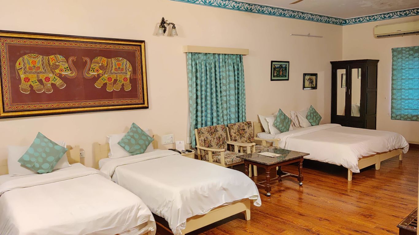 Two twin and one double bed at the family room at Suryaa Villa Jaipur