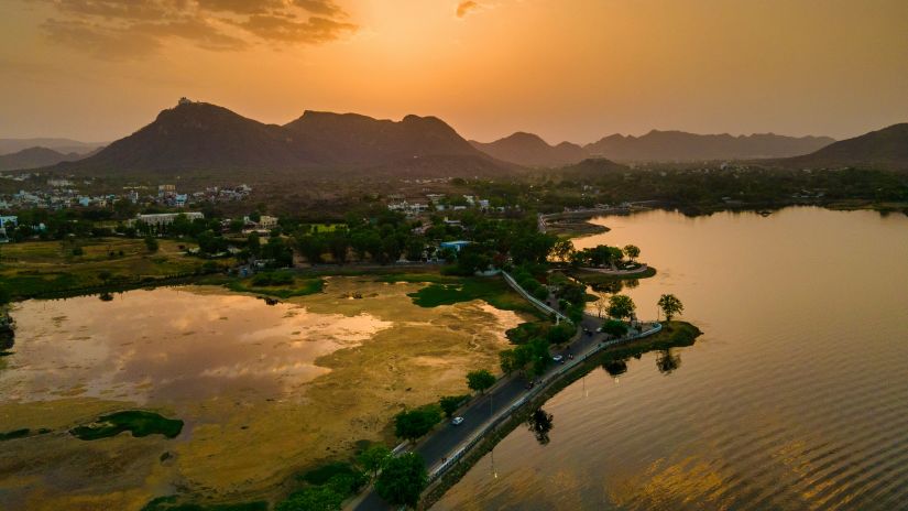 An overview of Fateh Sagar Lake with the evening sun in the background