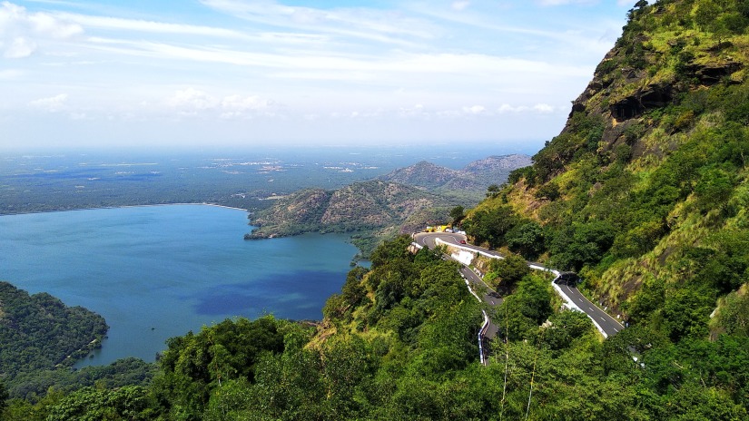 A lake surrounded by lush green hills