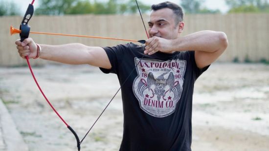 Man practising archery at inflated trampoline surrounded by trees at Themis Mudhouse - A Nature's Retreat Resort & Wellness