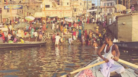 A photo of a man riding the boat in The Ganga