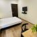 A double bed and a work desk with flowers at Sanctum Suites Richmond Road Bangalore