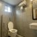 Image of a toilet and a washbasin in the washroom at Sanctum Suites Richmond Road Bangalore