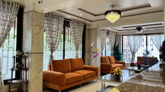 A close up shot of the hotel lobby with orange couches placed in front of coffee tables - VITS Select Kharadi, Pune