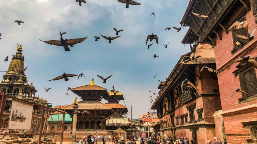 a cinematic view of the temple filled with devotees