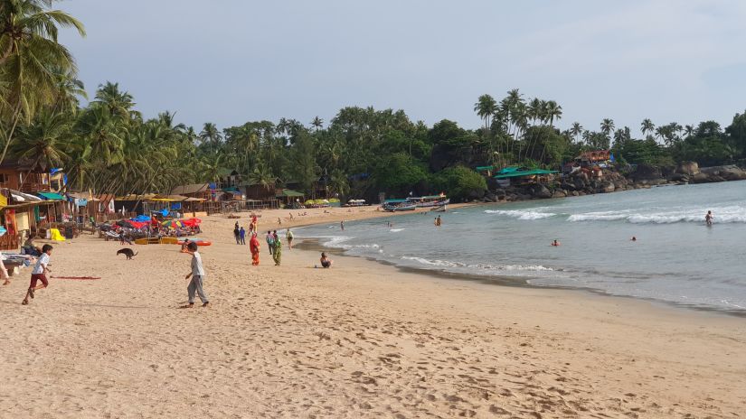 People strolling near Majorda Beach during daytime