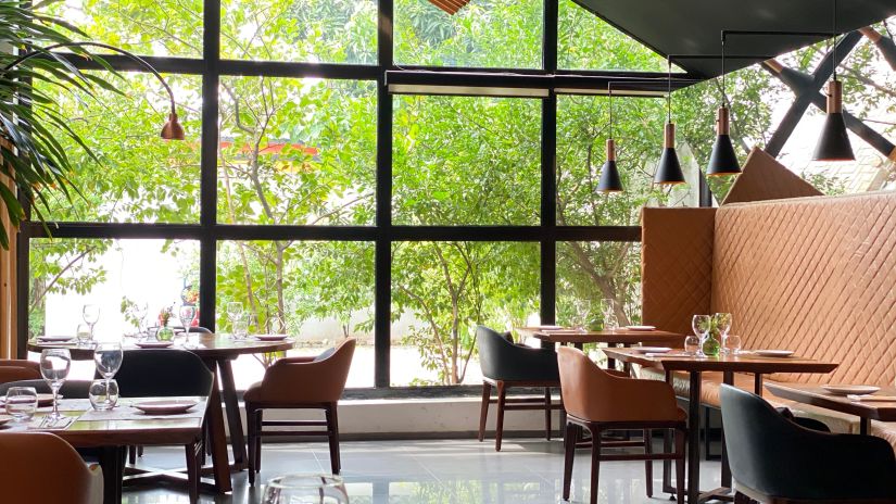 View of dining area with several tables and chair, all designed in contemporary style - Mastiff Grand- The Sia Palace Suites and Banquets, Khopoli