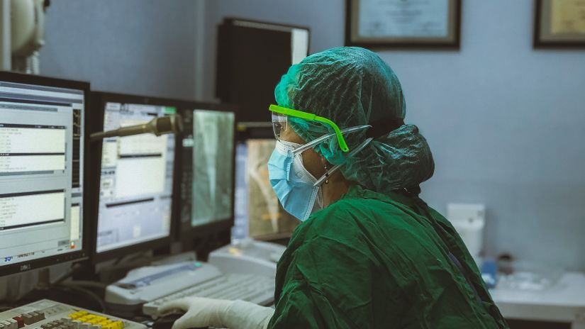 a doctor in a hospital looking at a monitor figuring out the reports