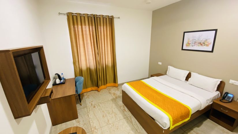 Super Deluxe Room side view double bed and wardrobe - Southern Grand Kashi