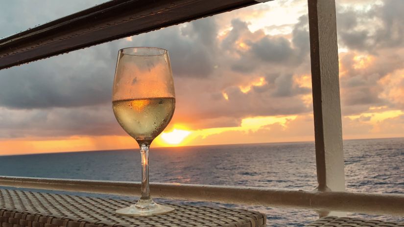 a wine glass placed near the deck of a ship