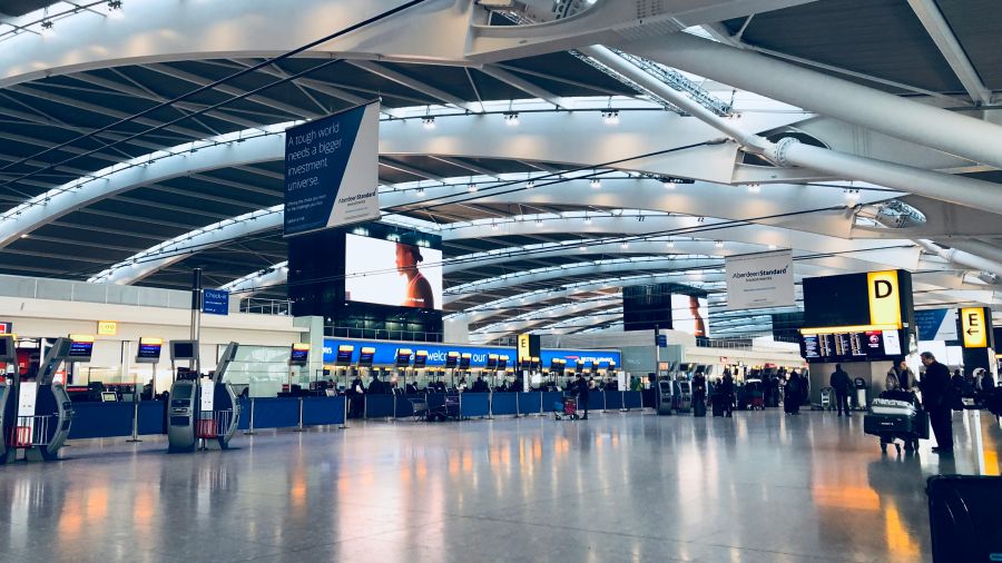 an overview of inside an airport terminal with screens and lights everywhere