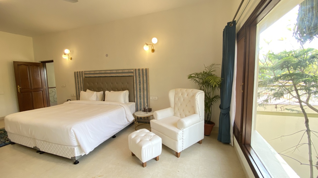 crisp white bedsheets and matching white furniture in one of the bedrooms in Villa 24 - 11