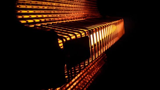 an illuminated red light coming out of a room heater