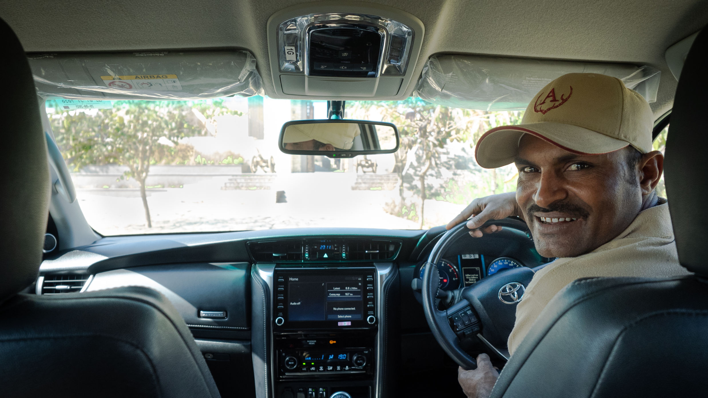 Image of the Interiors of the a Car Along With the Driver