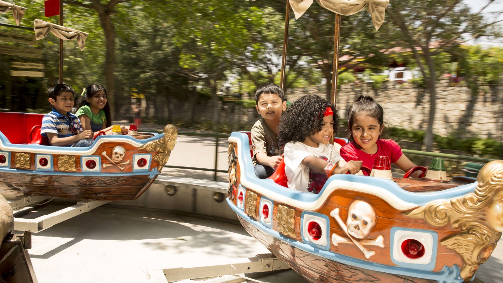 Kids enjoying an artificial boat ride at Wonderla Bengaluru