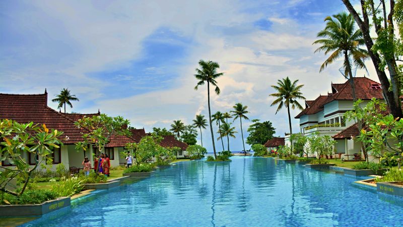 Swimming pool in the centre with resort buildings on the sides