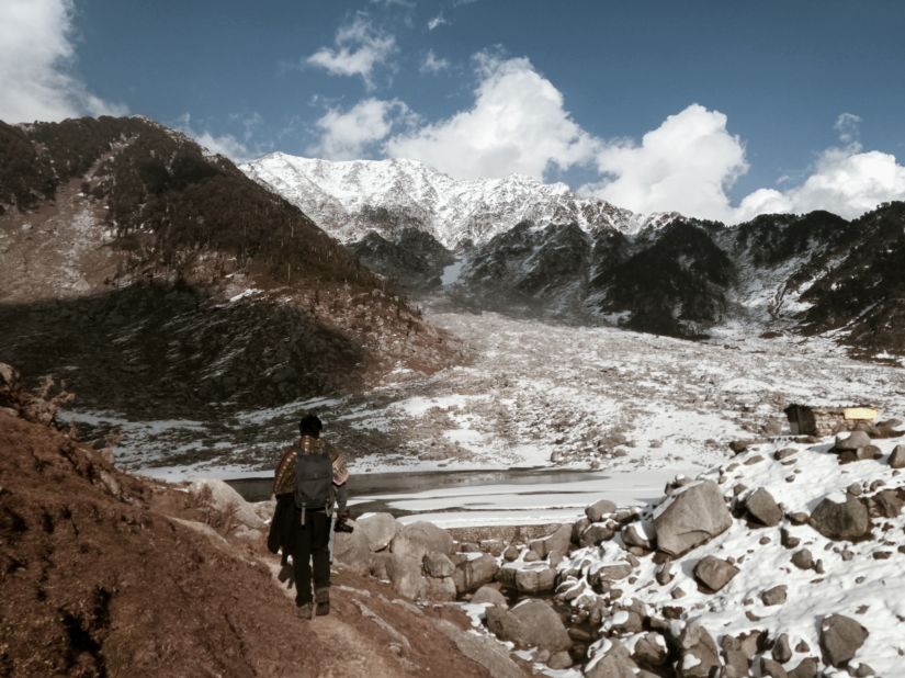 A guy trekking with the background of breathtaking mountain views