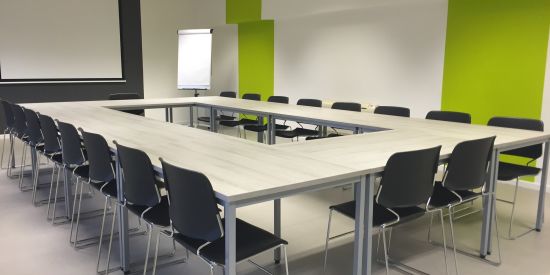 alt-text The meeting room has a conference table with a center cutout