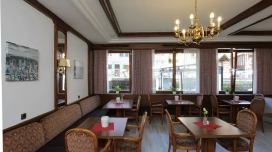 A shot of the dining area with tables and chair arranged in a organised way | Hotel Sonne by Mastiff, Bad Wildbad