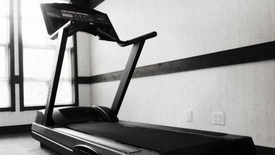 a black and white image of a treadmill at the fitness centre at Hotel Marine Plaza Mumbai