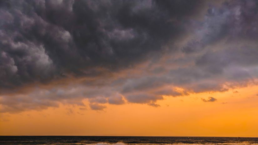 A view of Calangute Beach in the evening with dark clouds above just after the sunset