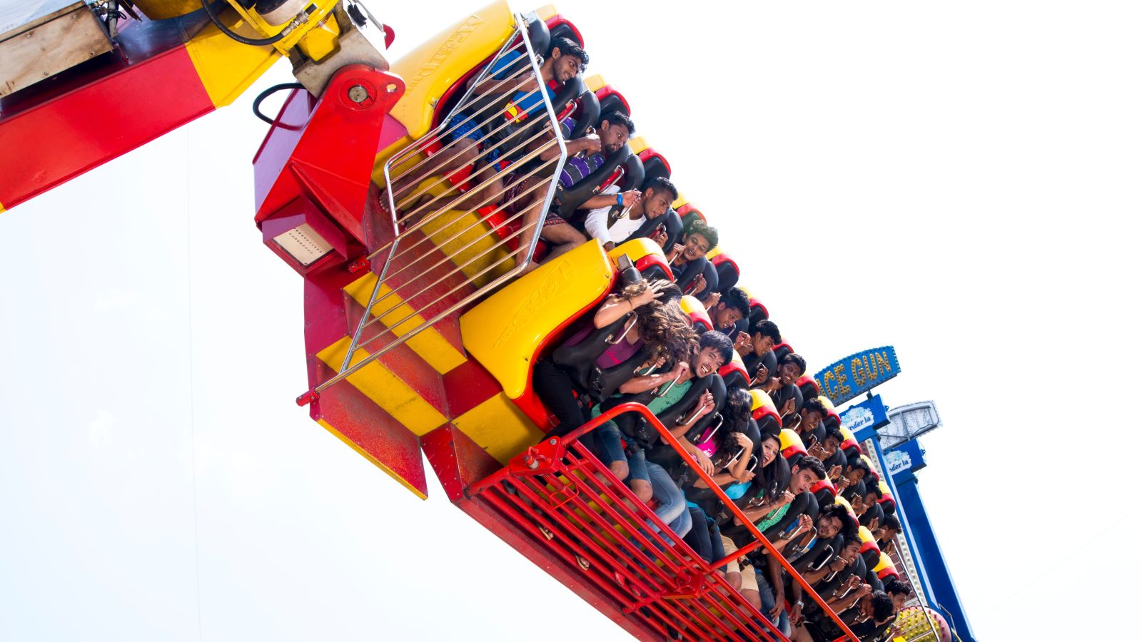 People seated on a ride tilted horizontally at a height