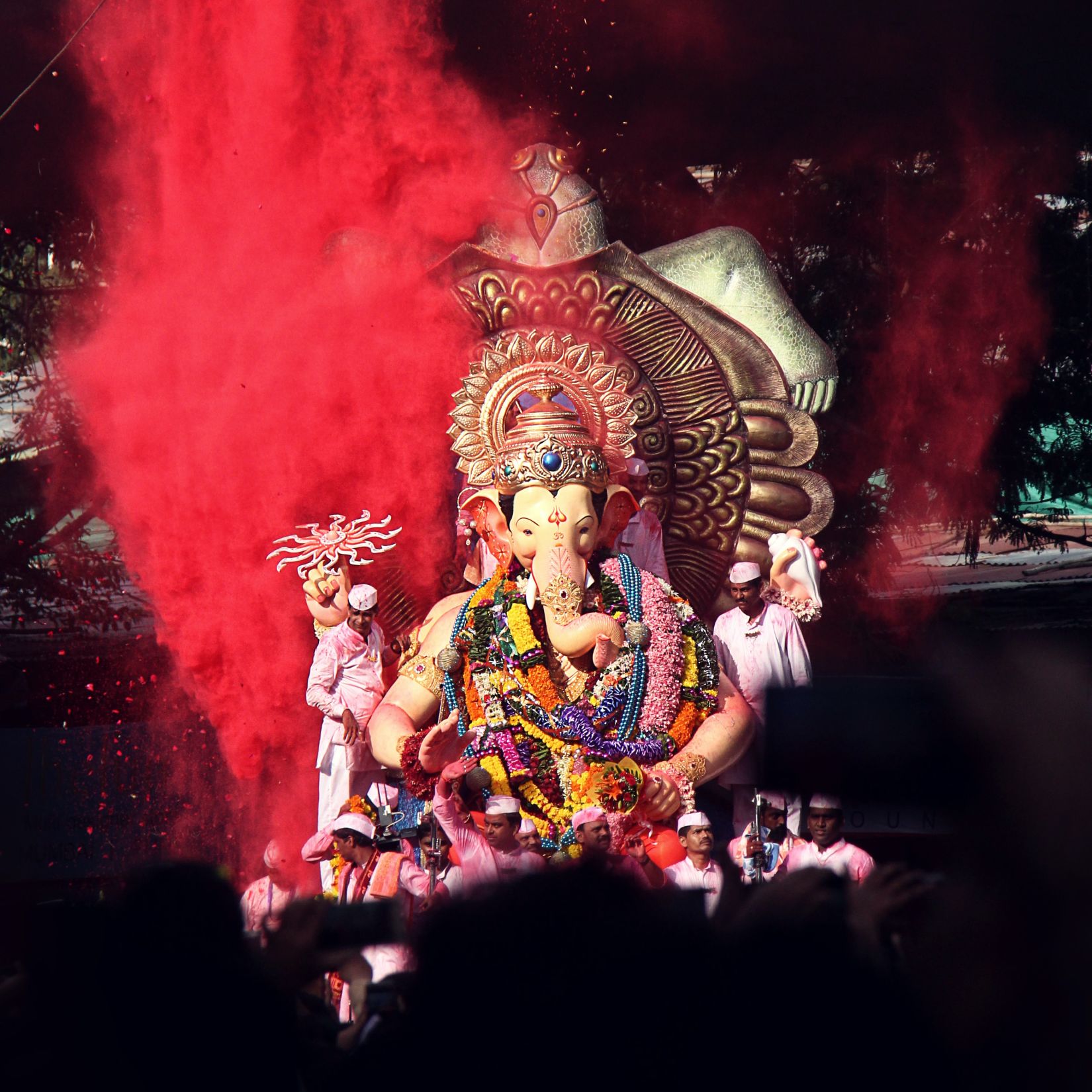 People accompanying a huge idol of Lord Ganesh for the procession