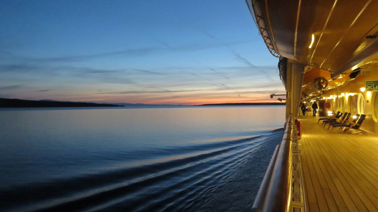 A shot of the sea taken from the cruise such that a part of the ship is seen on the edge of the photograph xwbtdy